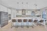 Gourmet kitchen featuring stainless steel appliances, gas cooktop, ample prep space & abundant cabinetry.