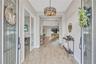 Double door entry opens to a light-filled space where designer details immediately set the tone.