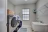 Large, well-appointed laundry room with utility sink - designed to make daily routines effortless and efficient.