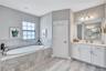 Dual vanities provide plenty of space, while separate water closet adds an extra layer of privacy.