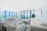 Direct ocean views from the spacious living area with floor-to-ceiling glass.