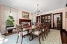 Formal and fabulous with wood burning fireplace, original built-in breakfront and glassware closet, oversized windows, wood floors, moldings and swing