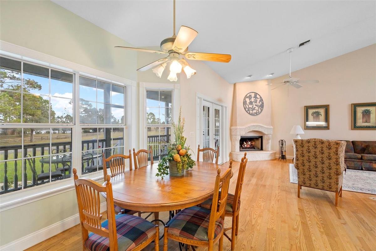 Kitchen table to living room with fireplace.