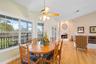 Kitchen table to living room with fireplace.