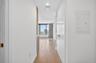 Hallway entry featuring wood-finish flooring and a bright, neutral color palette