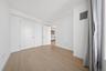 Light wood-finish flooring complements white walls and trim throughout this room