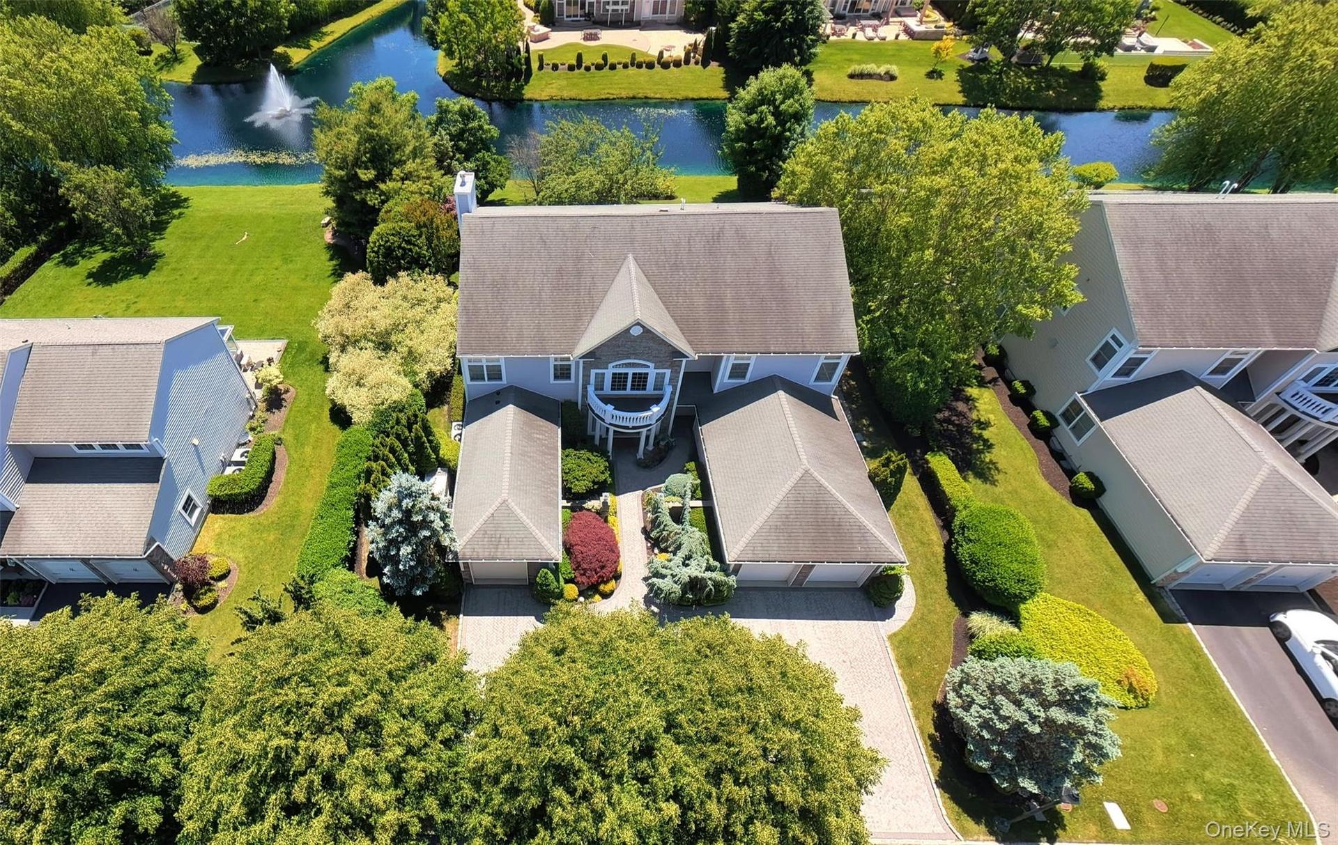 Two-story residence with a gray shingle roof, light blue siding, and white trim