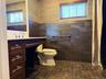 Bathroom featuring a dark wood vanity with a white countertop and chrome fixtures