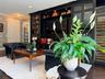 Built-in media cabinet featuring open shelving and glass-front display cabinets