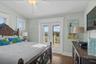 Top floor guest bedroom with balcony