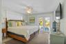 Main floor primary bedroom with balcony
