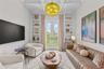 Living room with built in shelving a french doors to patio