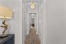 lGorgeous coastal engineered  white oak wood flooring througout front long hallway with  laundery closet