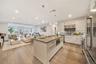 Kitchen with visible vents, appliances with stainless steel finishes, modern cabinets, open shelves, and a sink