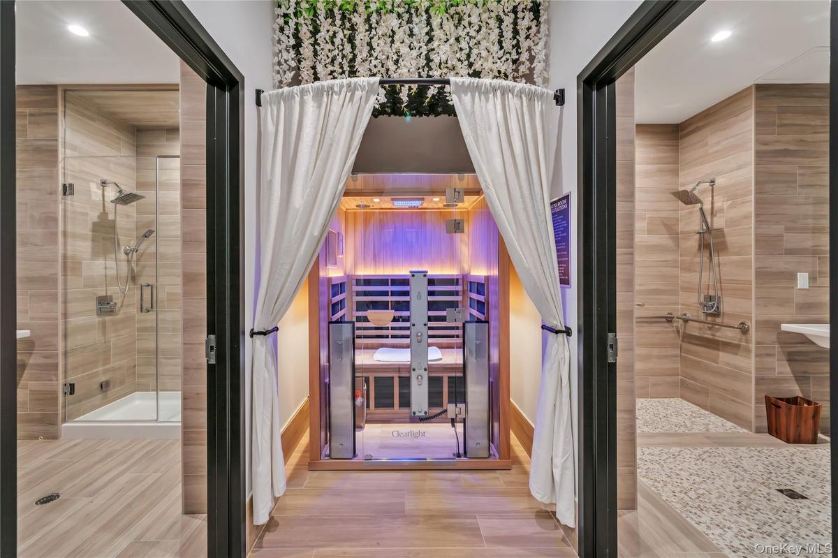 Bathroom with recessed lighting, a stall shower, baseboards, and wood finished floors