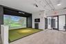 Game room featuring visible vents, golf simulator, and wood finished floors