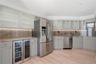 Large bar area with new dual-zone wine & beverage fridge. New oven, microwave & dishwasher. Under cabinet lights throughout
