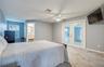 First Floor Primary Bedroom with En Suite and French Doors closed to Pool Area