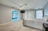 First Floor Primary Bedroom open to Living Area and French Doors open to Pool Area