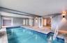 Indoor Pool Area with French Doors to Living Area open and access to inside stairway