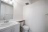 Bathroom featuring a vanity with an integrated sink, chrome faucet, and mirrored wall