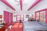 Bedroom 1 With Beamed Ceiling, Carpet with hardwoods under