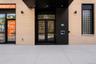 Building exterior featuring light-colored brickwork with black accents