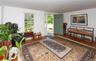 Entryway featuring a paneled front door, hardwood flooring, white trim, and a window providing natural light