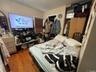 Bedroom with arched walkways and wood finished floors