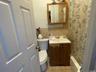 Bathroom with toilet, tile patterned flooring, and vanity