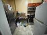Kitchen featuring light tile patterned floors and appliances with stainless steel finishes