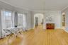 Dining space featuring ornamental molding, arched walkways, and light wood finished floors