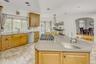 Kitchen with decorative backsplash, light tile patterned floors, appliances with stainless steel finishes, a center island, and recessed lighting