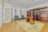 Office area with crown molding and light wood finished floors