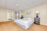 Carpeted bedroom with a drop ceiling
