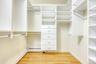 Spacious closet featuring light wood-style floors and a baseboard heating unit