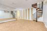 Finished basement with stairway, carpet flooring, a paneled ceiling, and wallpapered walls