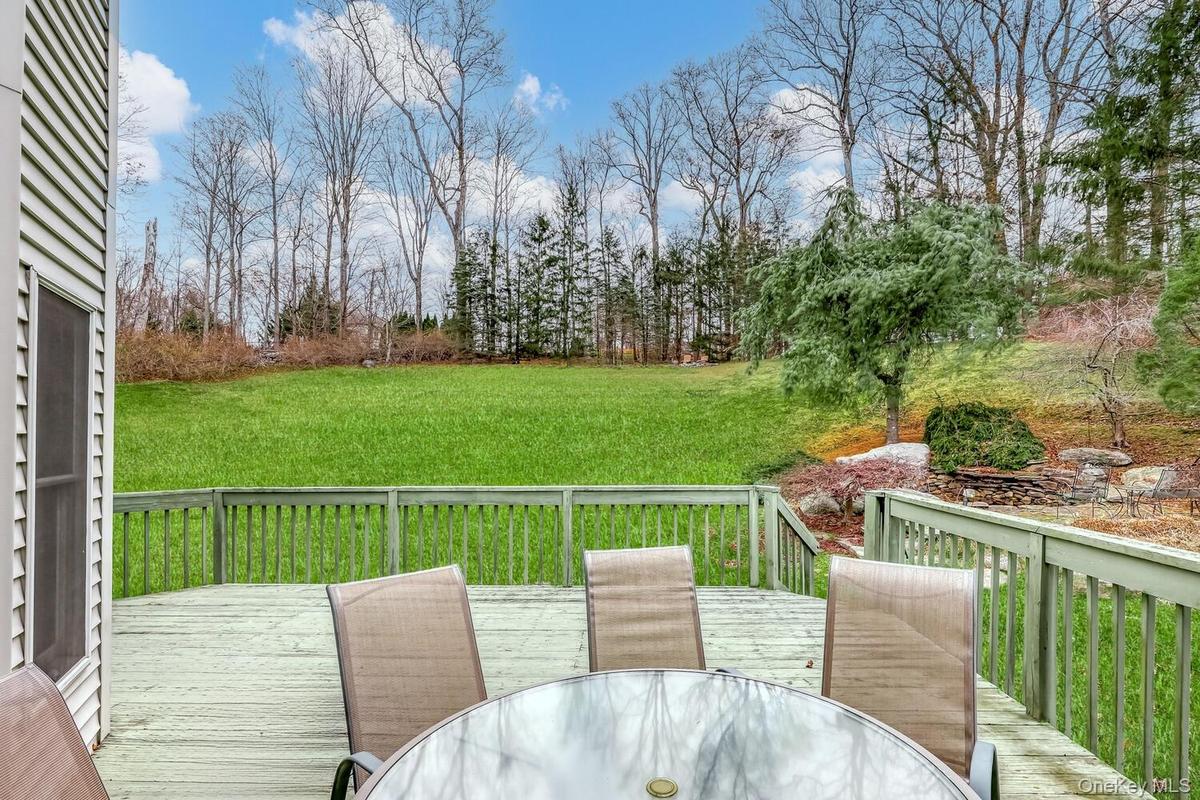 Deck featuring outdoor dining space and a lawn