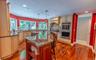 Chef's dream kitchen showcasing custom cabinetry, magnificent granite countertops, and a massive center island with seating. Equipped with premium sta