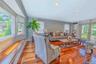Sun-drenched den with gorgeous hardwood floors, modern recessed lighting, and seamless backyard access.