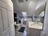 Apt bathroom with washer and dryer