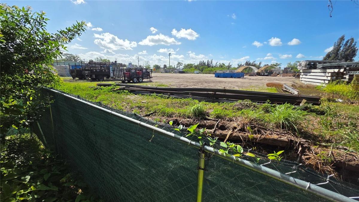 Looking over the Green Fence at end of 49th Street cul-de-sac.ZONING CONSIDERATION: In 2005, this Southerly neighboring commercial lot (046606 - see p