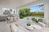 Outside living room with kitchen overlooks pool