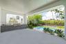 Outside living room with full kitchen overlooks pool