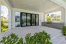 Outside living room with full kitchen overlooks pool
