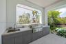 Outside living room with kitchen overlooks pool