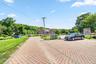 The expansive parking area in front of the home offers ample space for multiple vehicles and a variety of additional uses.