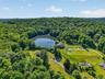The developed portion of the two parcels includes a total of six single-family homes, offering flexibility for use as a private compound or an income-