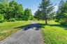 Approach the home via a picturesque driveway framed by meticulously maintained grounds.