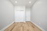 Refinished wood-finish flooring complements light gray walls